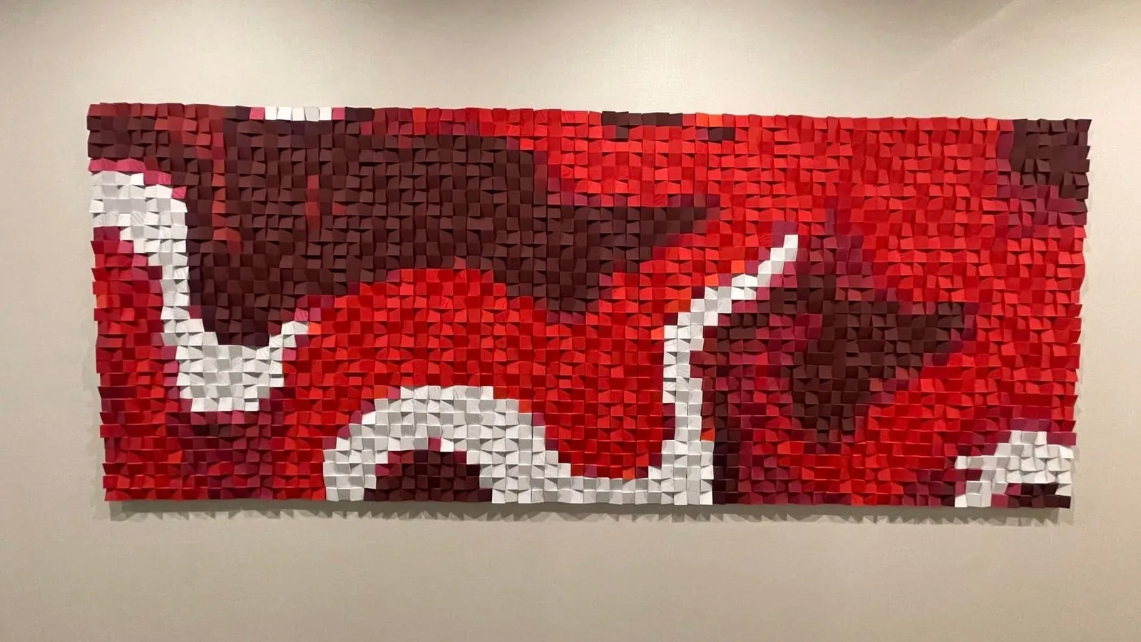Red and white wood mosaic logo mural at the Coca-Cola Thailand head office, seen straight on